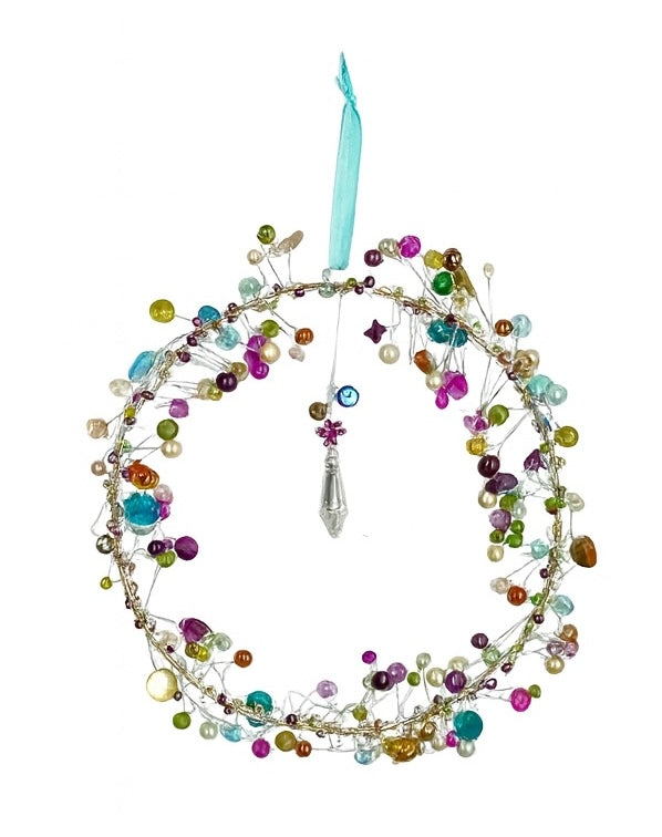 Decorative wreath ornament with colorful beads and a blue ribbon on a white background