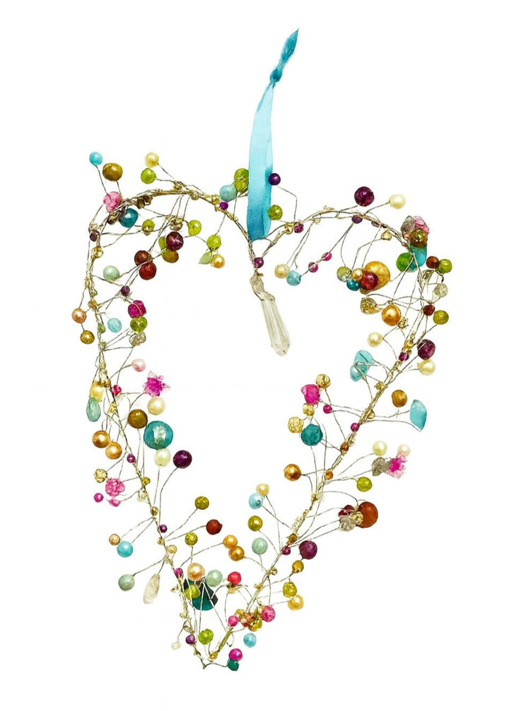 Multicolored beaded heart-shaped ornament on a white background