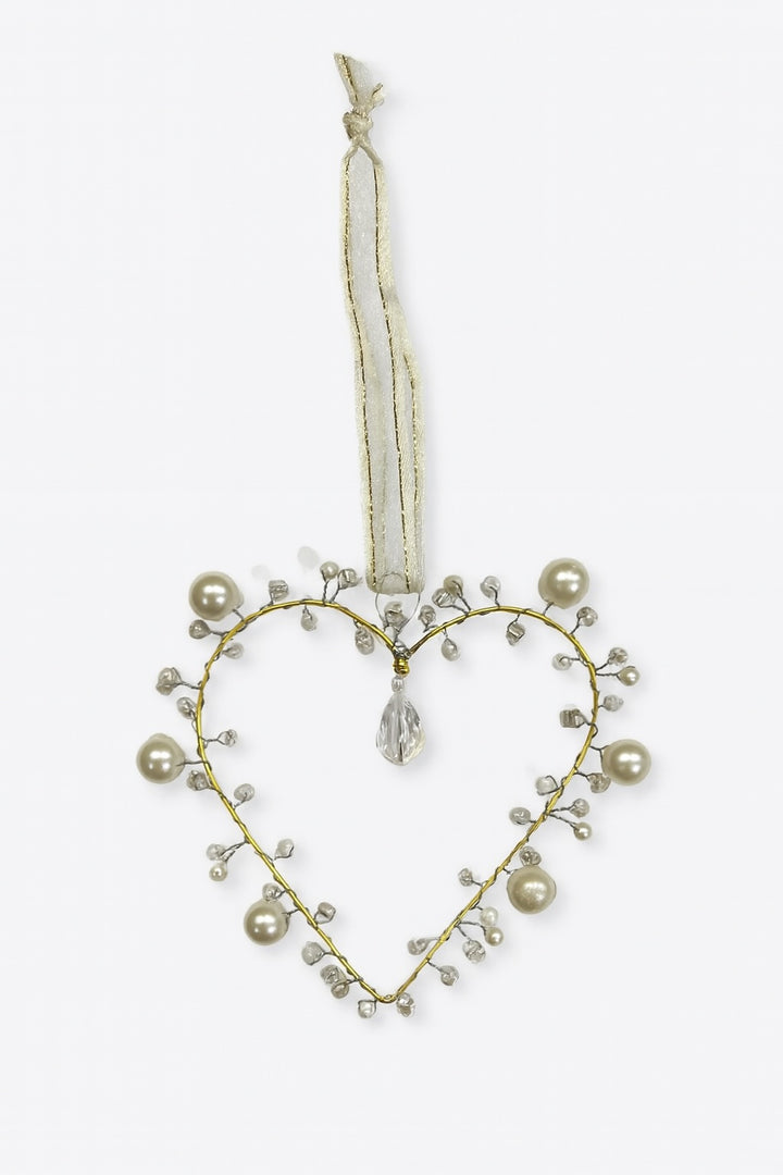 Heart-shaped decorative ornament with pearls and crystals on a white background