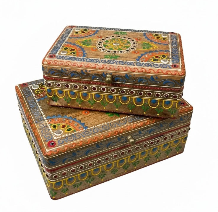 Two wooden boxes with colourful patterns on a white background