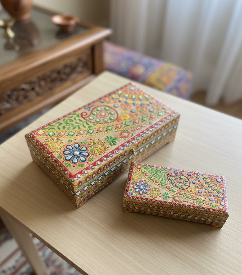 Decorative boxes with colorful patterns on a wooden surface.