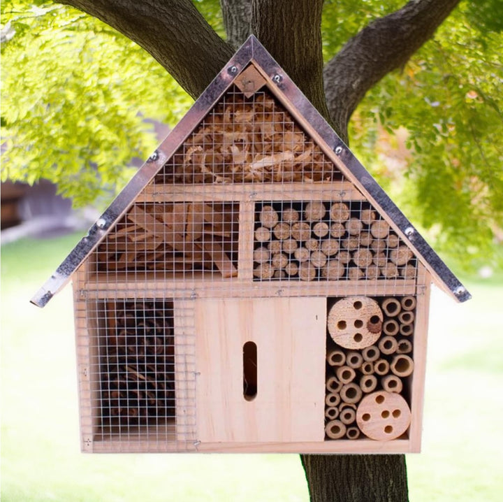 Insect Hotel in the garden made from Wood with a metal roof