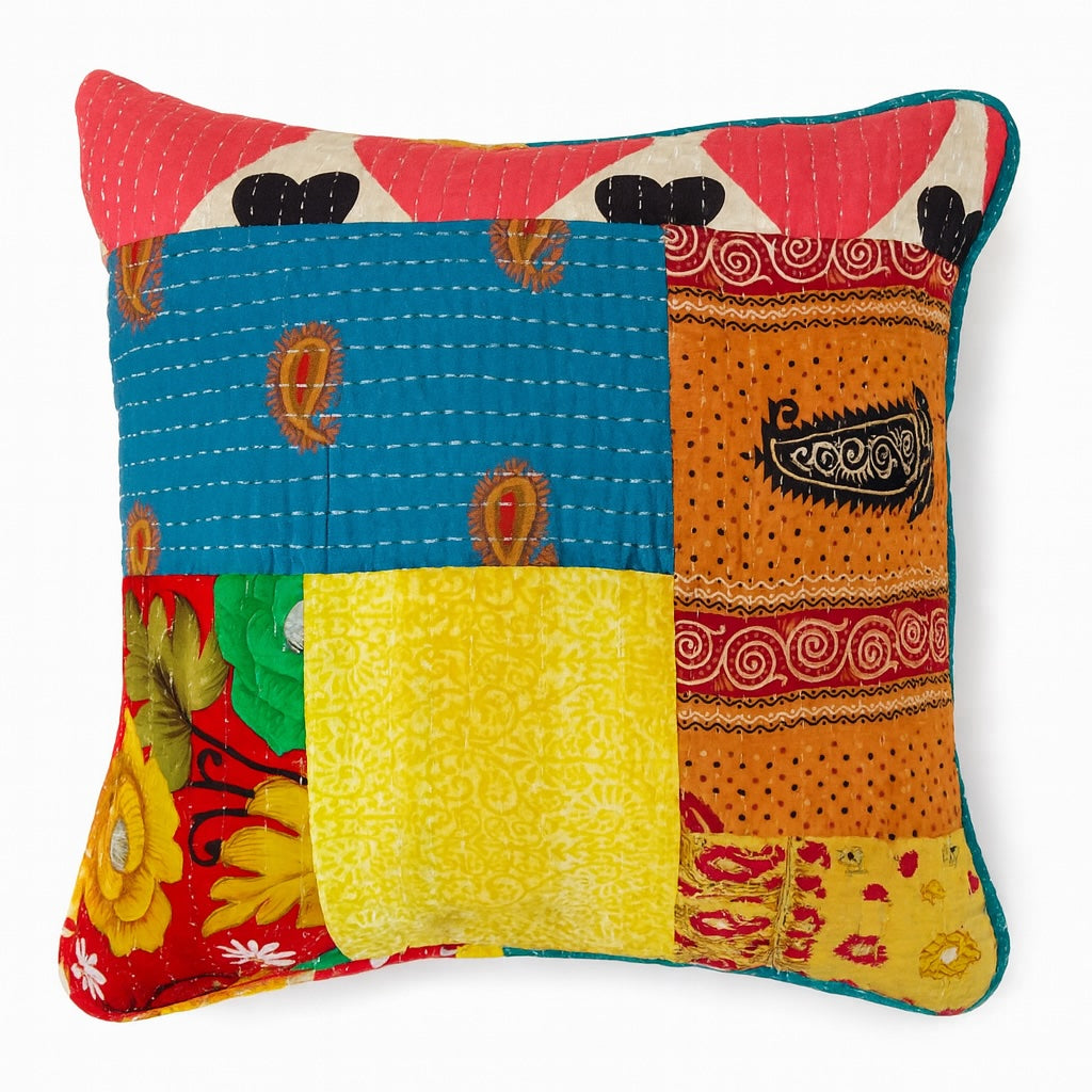 Colorful patchwork pillow with various patterns on a white background