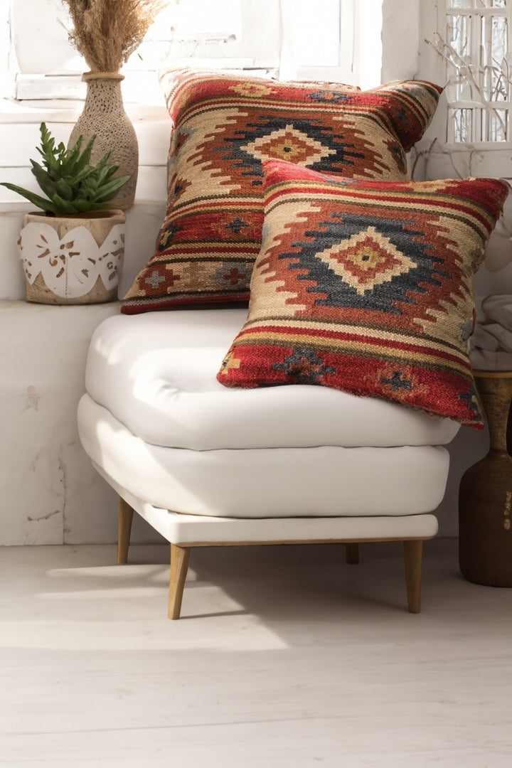 Pair of kilim cushion covers on a white chair 