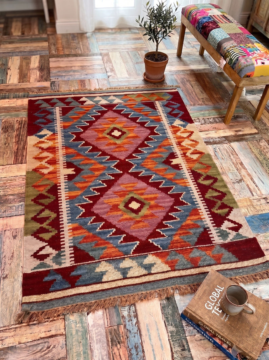 Wool Cotton Kilim On a wooden tiled floor with a bench and plant