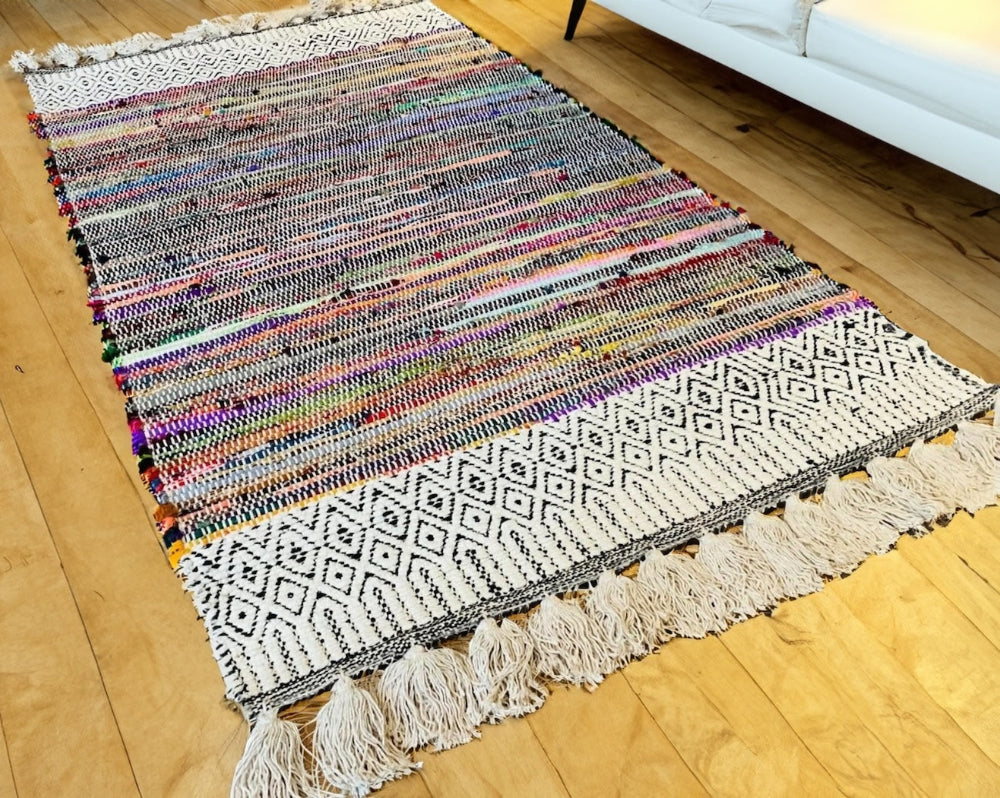 Chindi Rug With Chenille Geometric Pattern on a wooden floor.