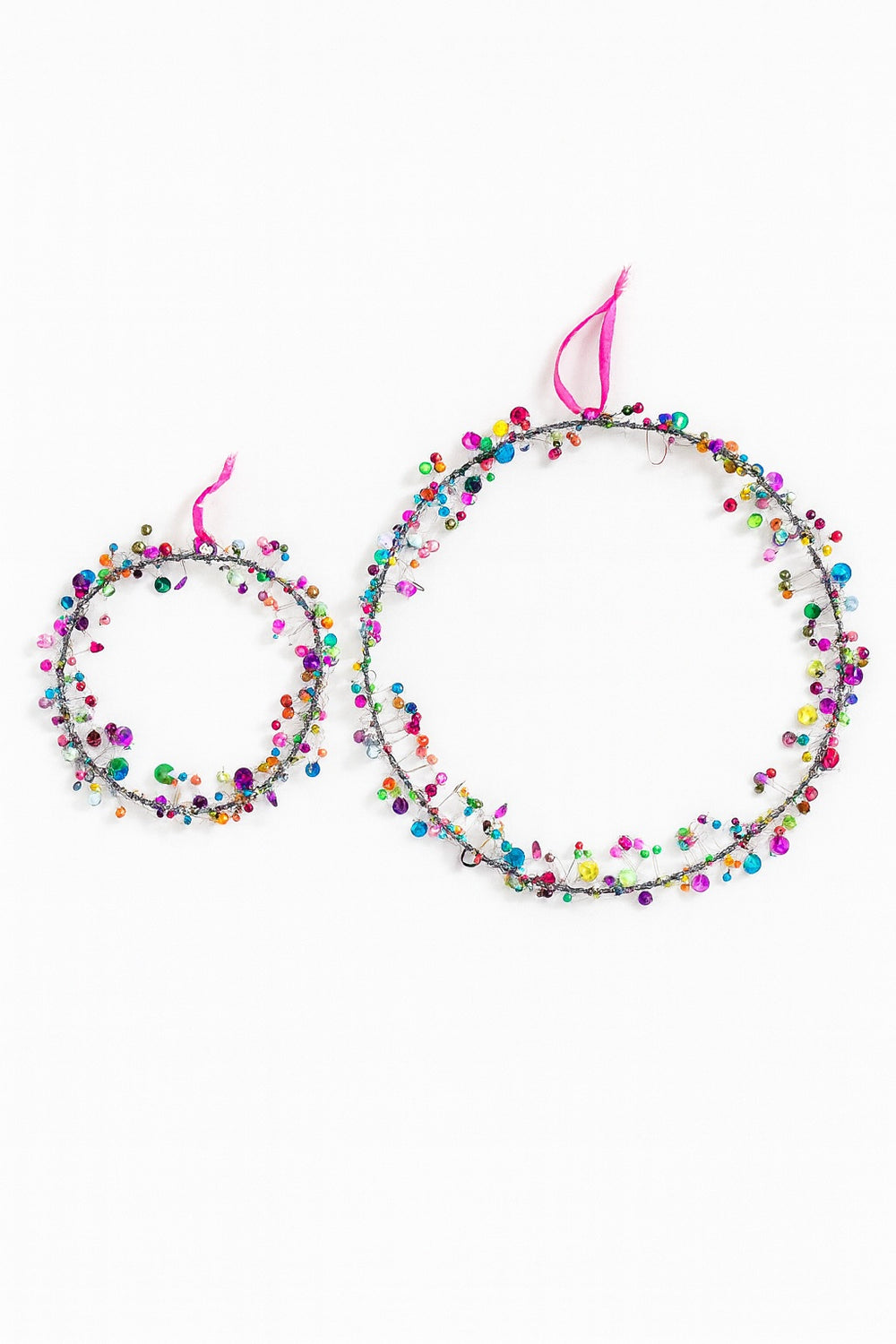 Colourful round hanging decoration with pink accents on a white background 