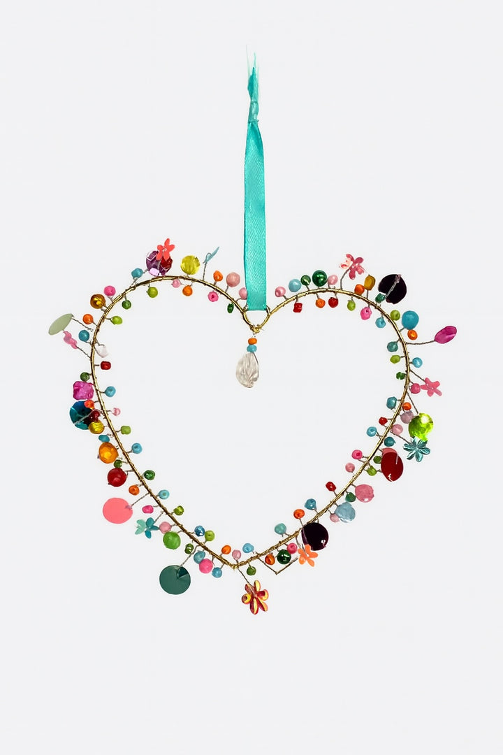 Love Heart-shaped hanging with colourful beads and a teal ribbon on a white background