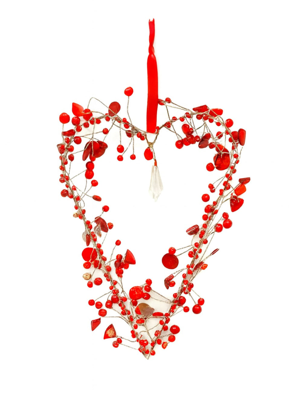 Heart-shaped decoration with red berries beads and a red ribbon on a white background