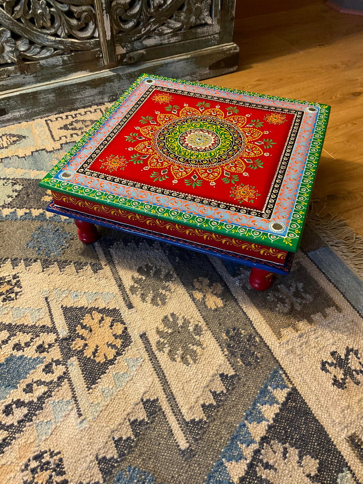 Decorative small table with intricate patterns on a textured rug