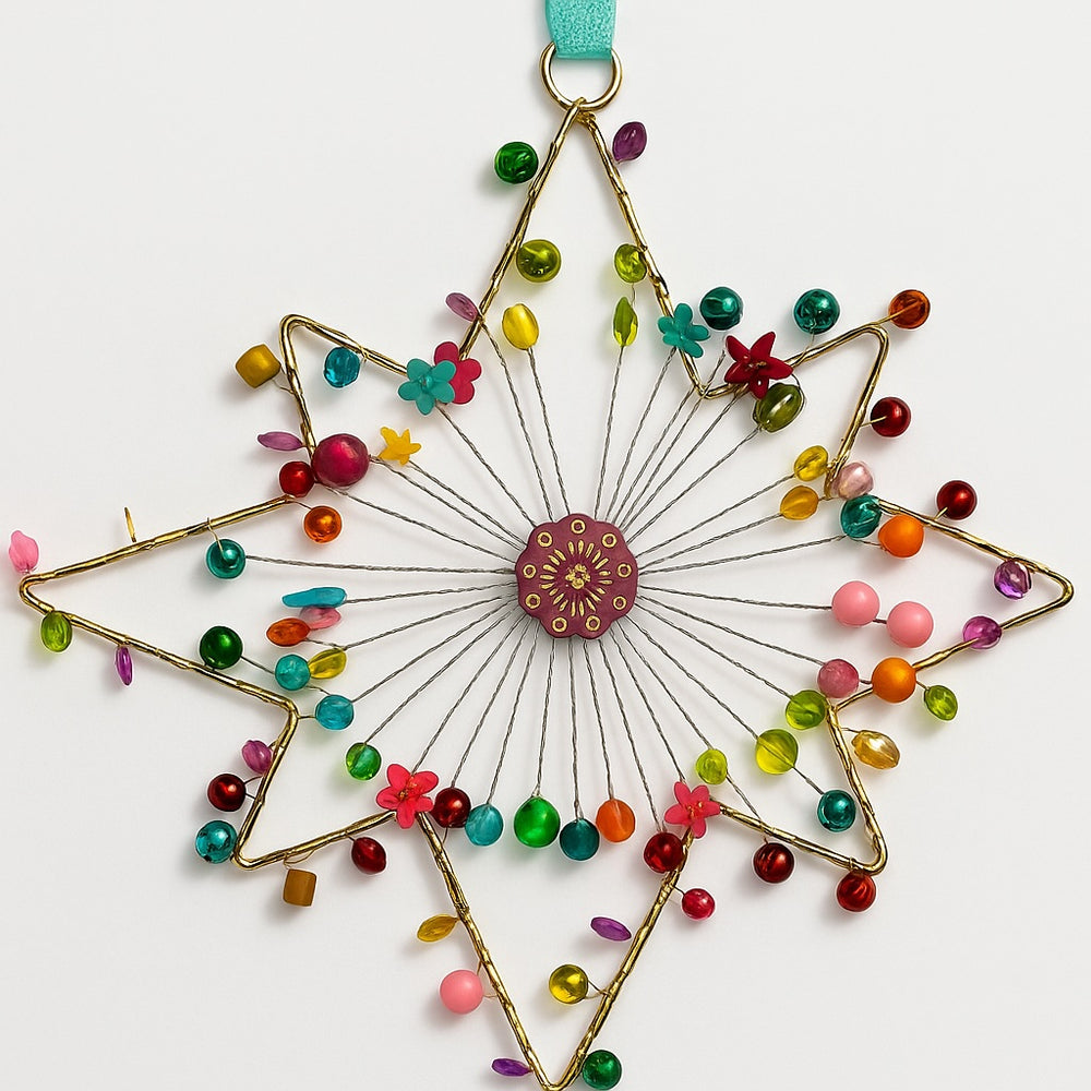 Decorative star-shaped ornament with colourful beads and flowers on a white background