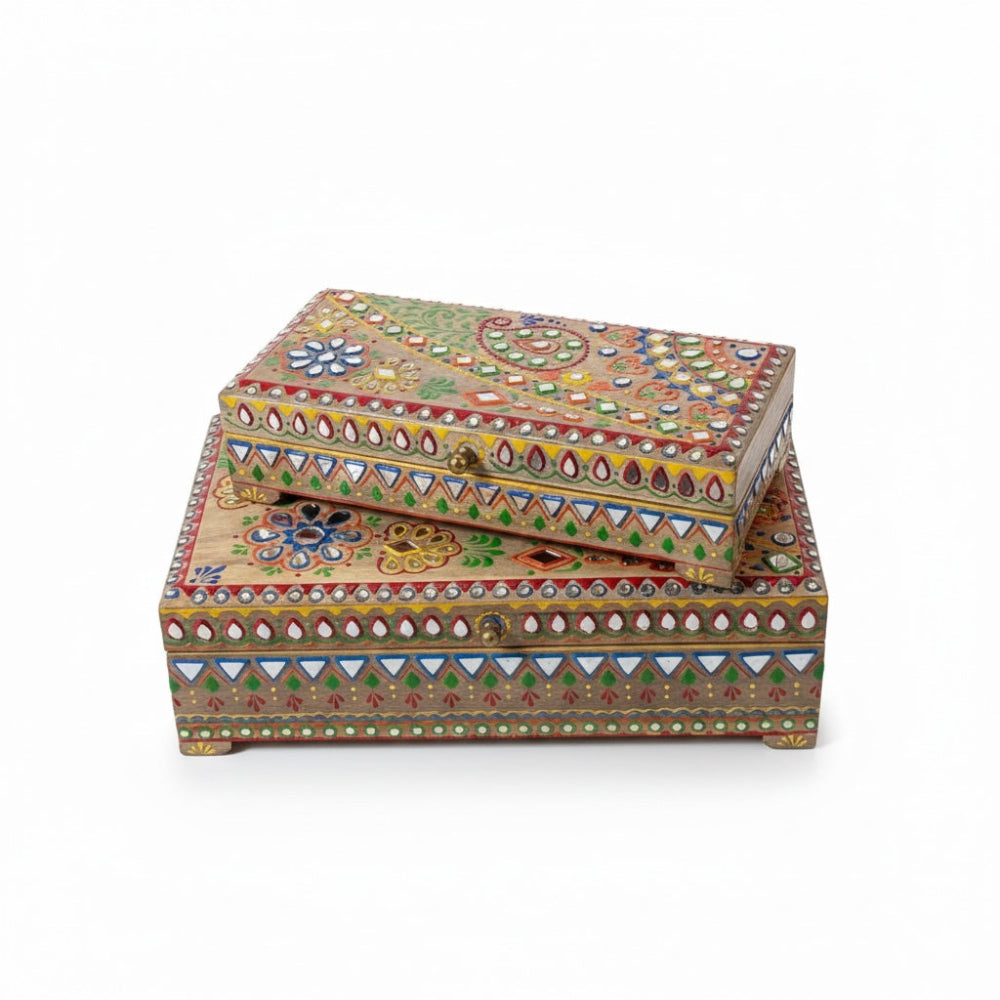Two colourful wooden boxes with intricate patterns on a white background