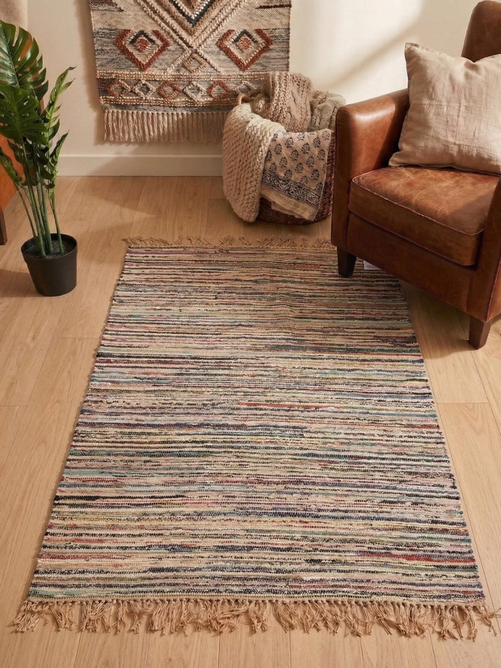 Multicolored striped rug on a wooden floor with a brown armchair and decorative elements.