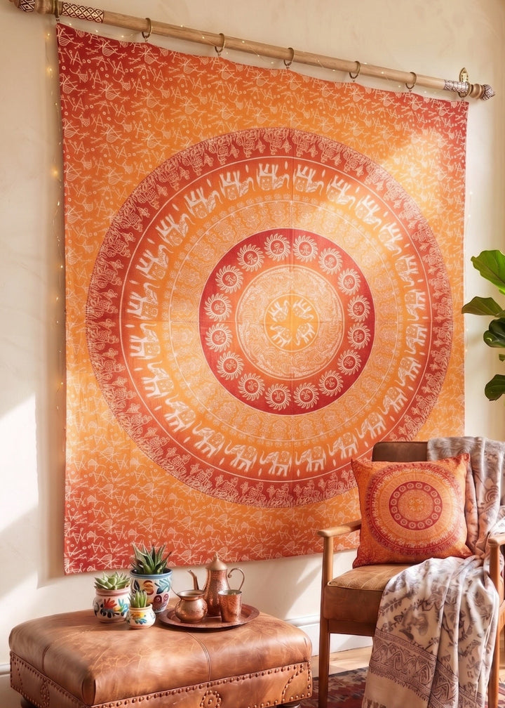 Decorative orange mandala tapestry hanging on a wall in a living room.
