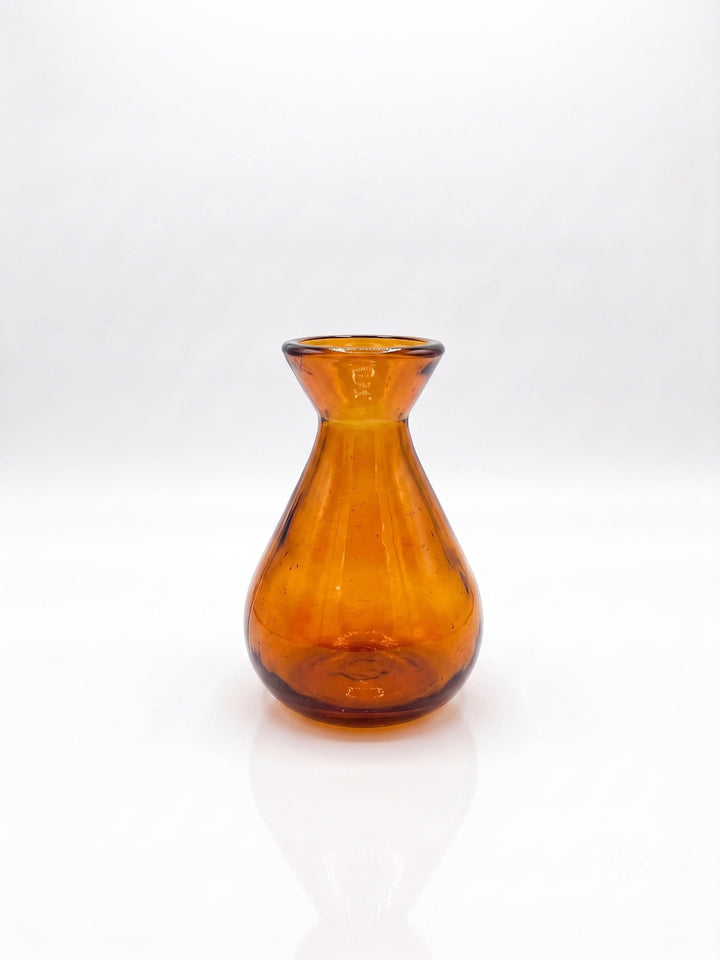 An amber glass vase with a flared rim and a rounded body, shown on a clean white background with a soft reflection below.