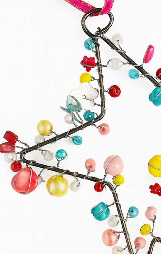 Decorative Star with colourful beads on a white background