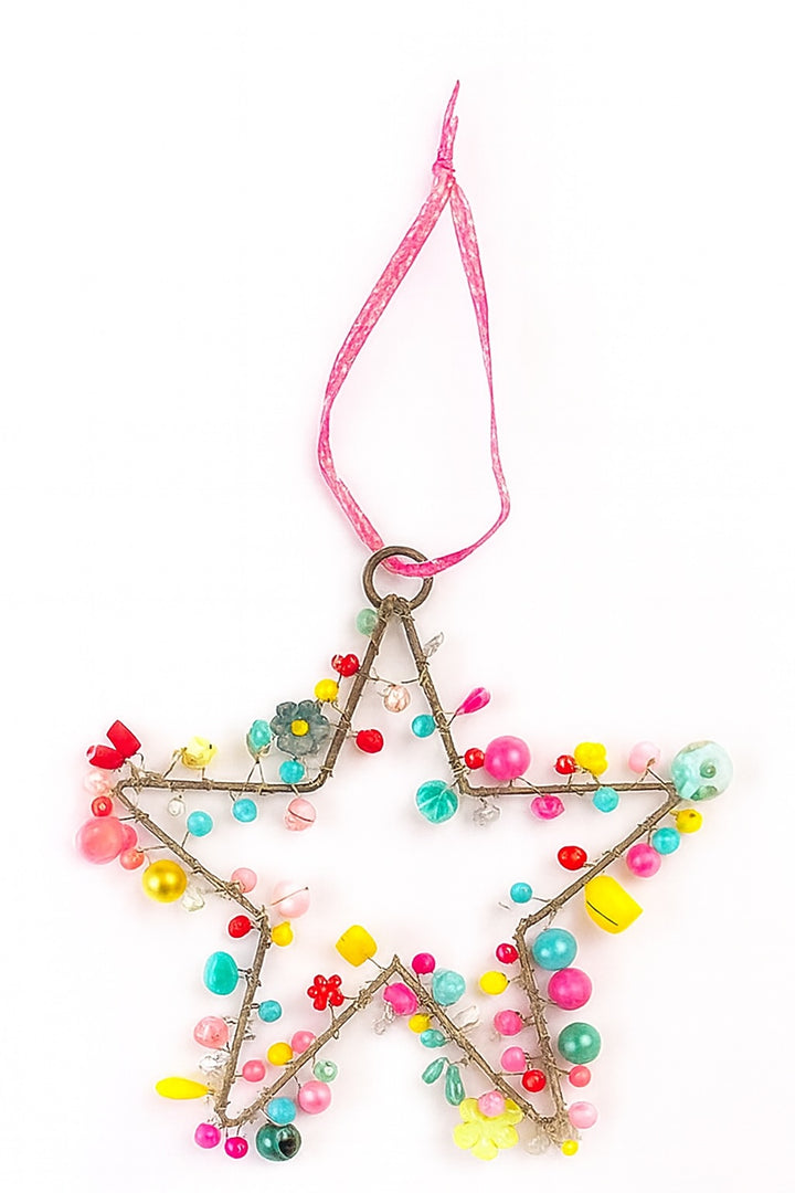 Star-shaped ornament with colourful beads and a pink ribbon on a white background