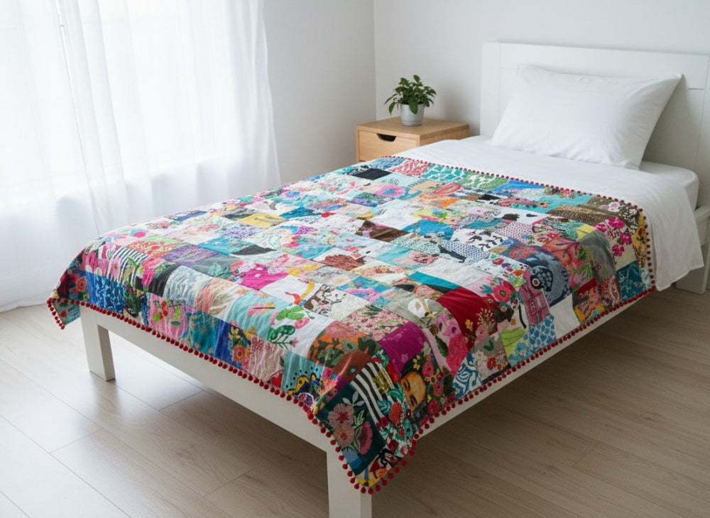 Colourful quilt on a bed in a bright bedroom
