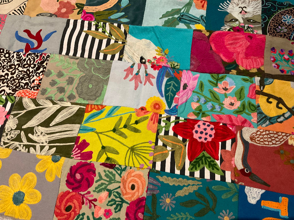 Collection of colourful fabric swatches with various patterns sewn into a blanket