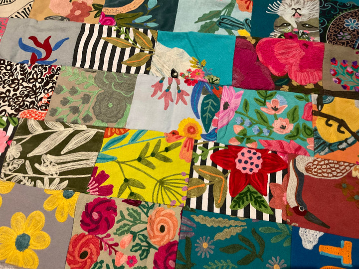 Collection of colourful fabric swatches with various patterns sewn into a blanket