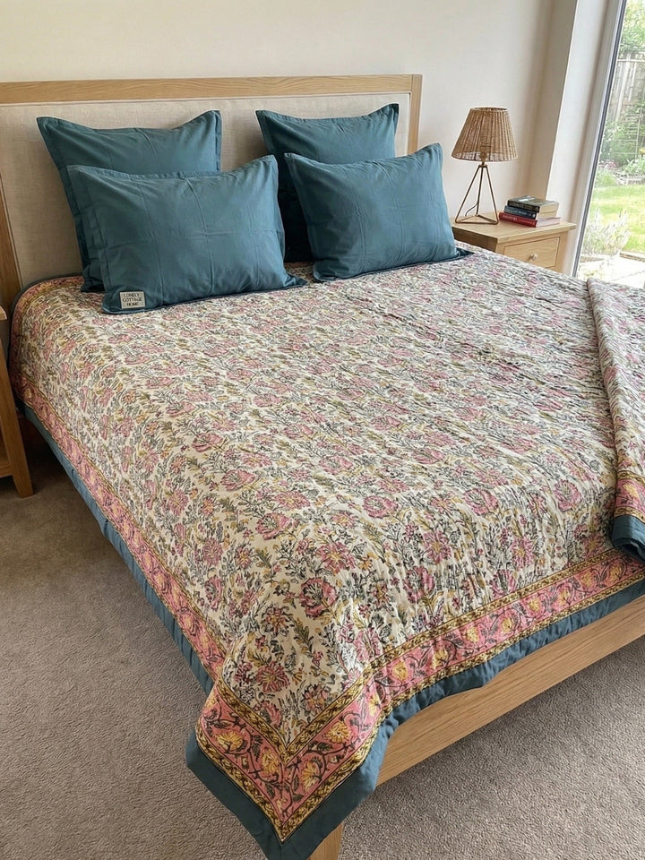 Pink Floral Cotton Duvet On a Bed with a bedside table and lamp
