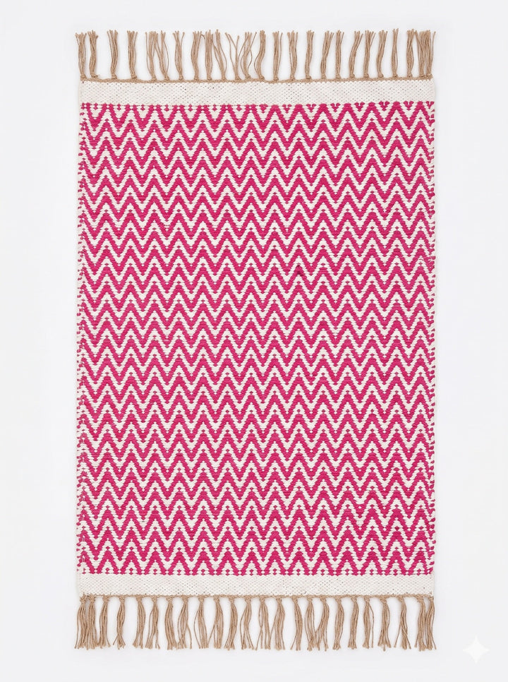 Pink and white chevron patterned rug with brown fringes on a white background