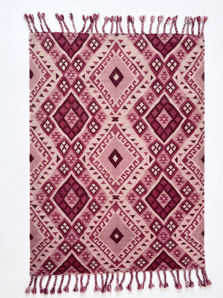 Pink Kilim Rug With Chunky Tassels In a White Background