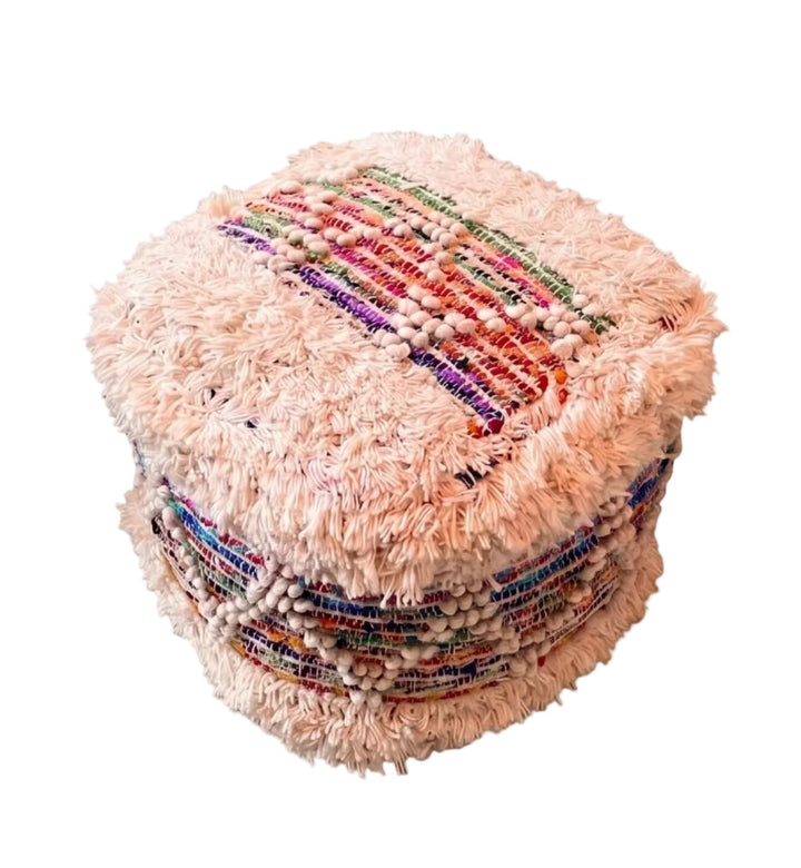 A square, shaggy pouf ottoman in a light cream/white colour featuring colourful woven stripes on top and sides, isolated on a white background.