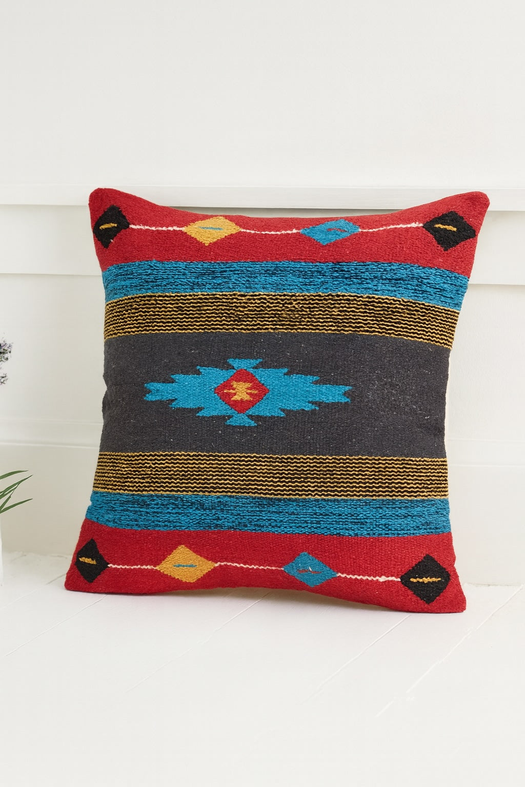 Decorative pillow with geometric pattern on a white background