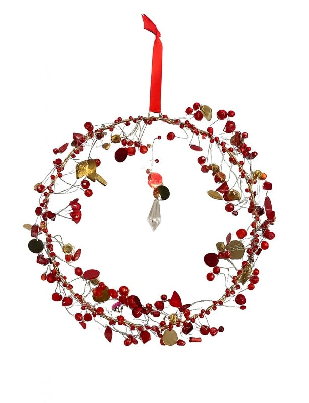 Decorative wreath with red beads and gold leaves on a white background