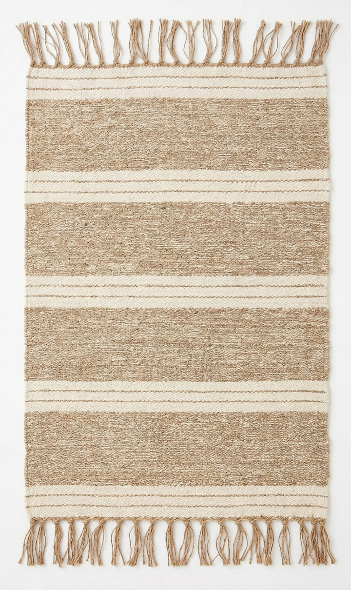 Striped jute rug with fringes on a plain background