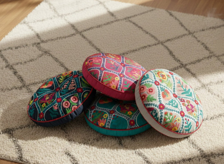 Colourful fabric-covered cushions on a textured surface