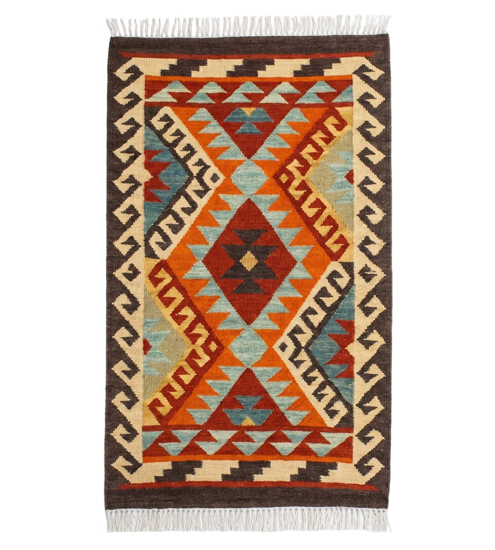 A rectangular woven kilim rug with a Southwestern geometric pattern in orange, red, brown, cream, and light blue, featuring white fringe on the top and bottom, shown against a plain white background.