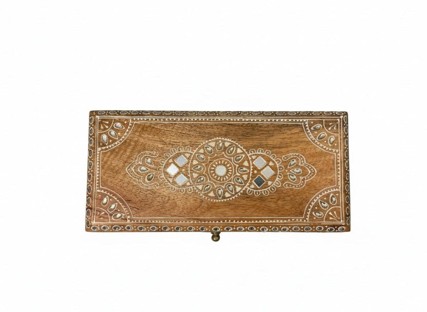 Decorative wooden box with intricate carvings on a white background