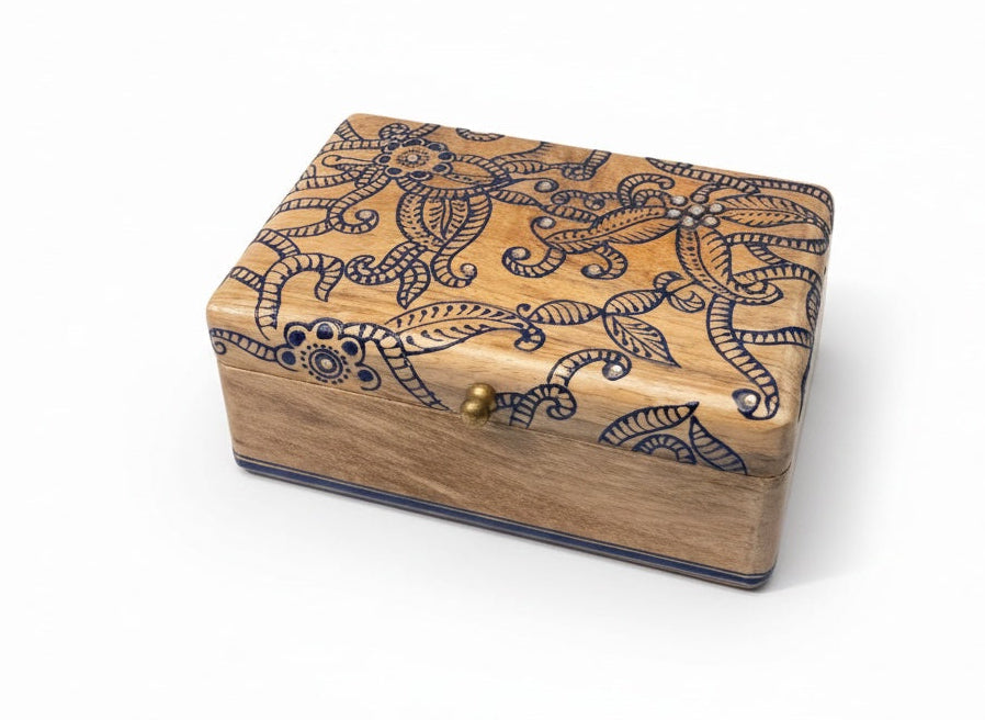 Wooden box with decorative patterns on a white background