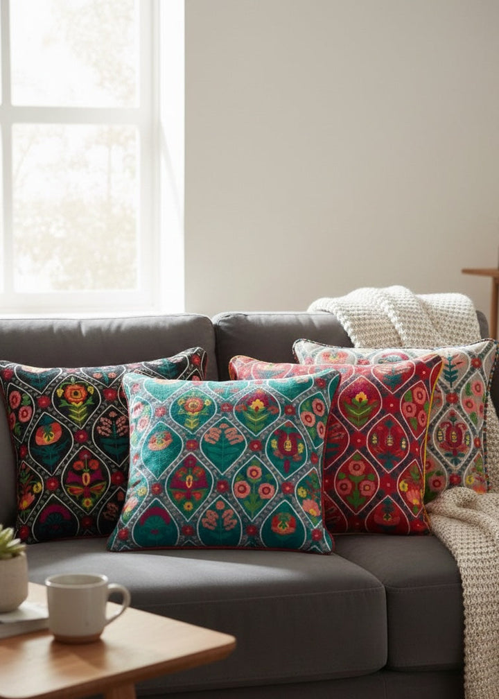 Decorative cushion with colourful patterns on a grey sofa in a living room.