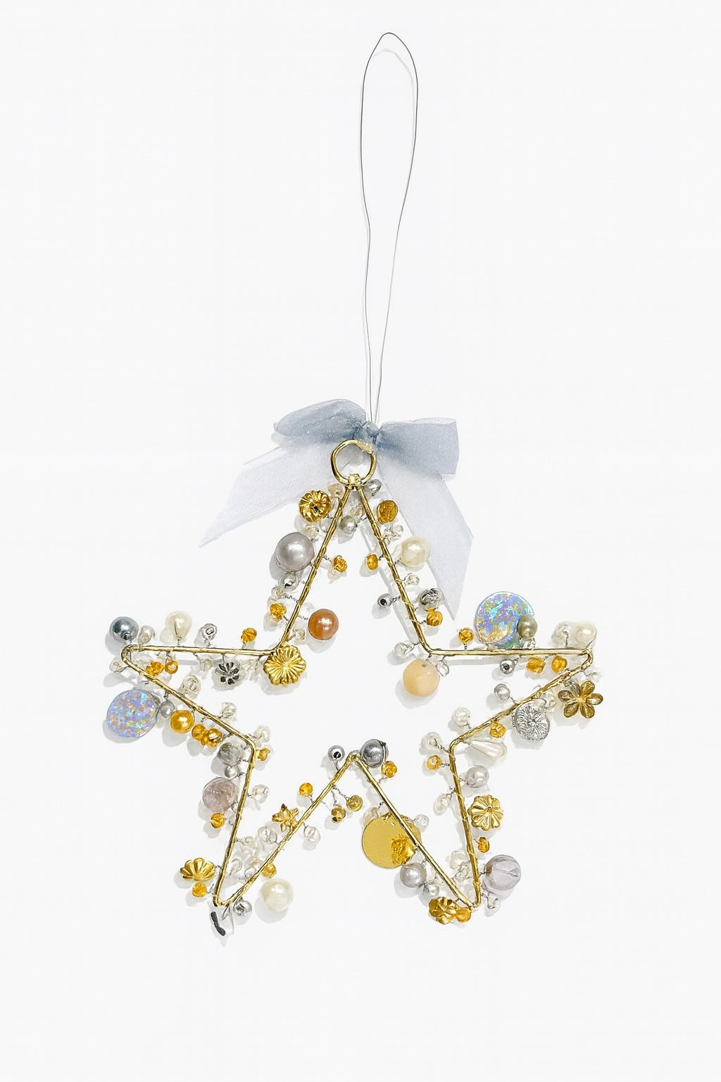 Decorative star ornament with beads and ribbons on a white background