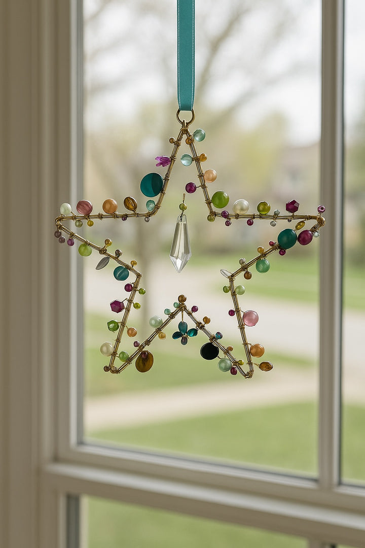 Decorative star hanging ornament with colorful beads on a window background