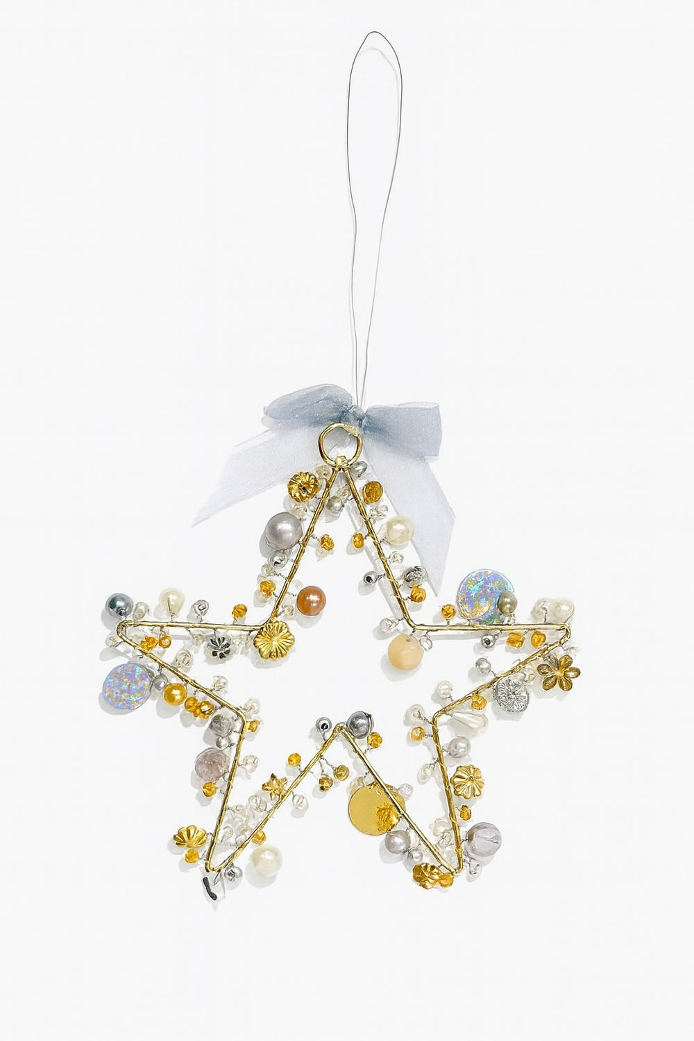 Decorative star ornament with beads and ribbons on a white background