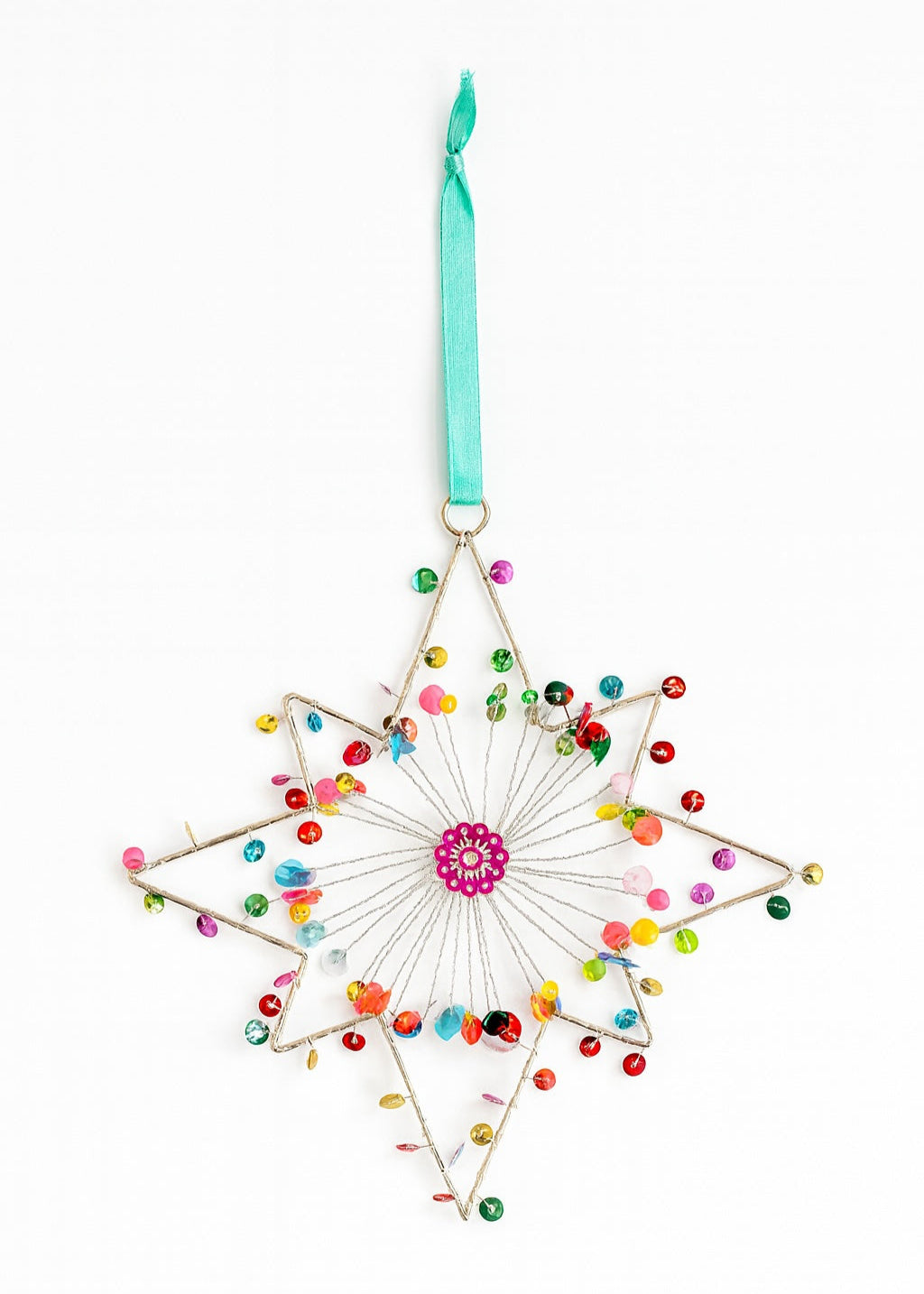Decorative star ornament with colourful beads and a pink centre on a white background