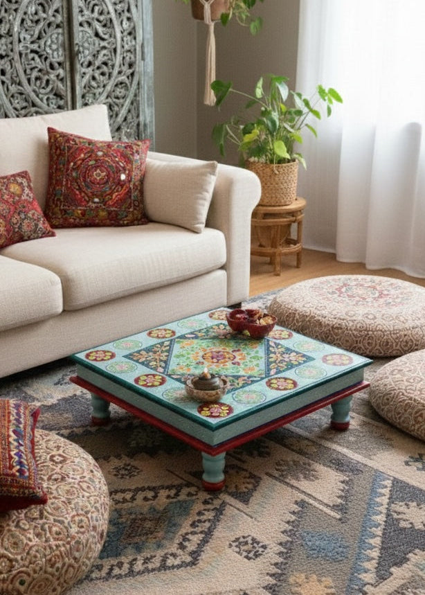 Living room with a decorative coffee table, patterned ottomans, and a couch with pillows.