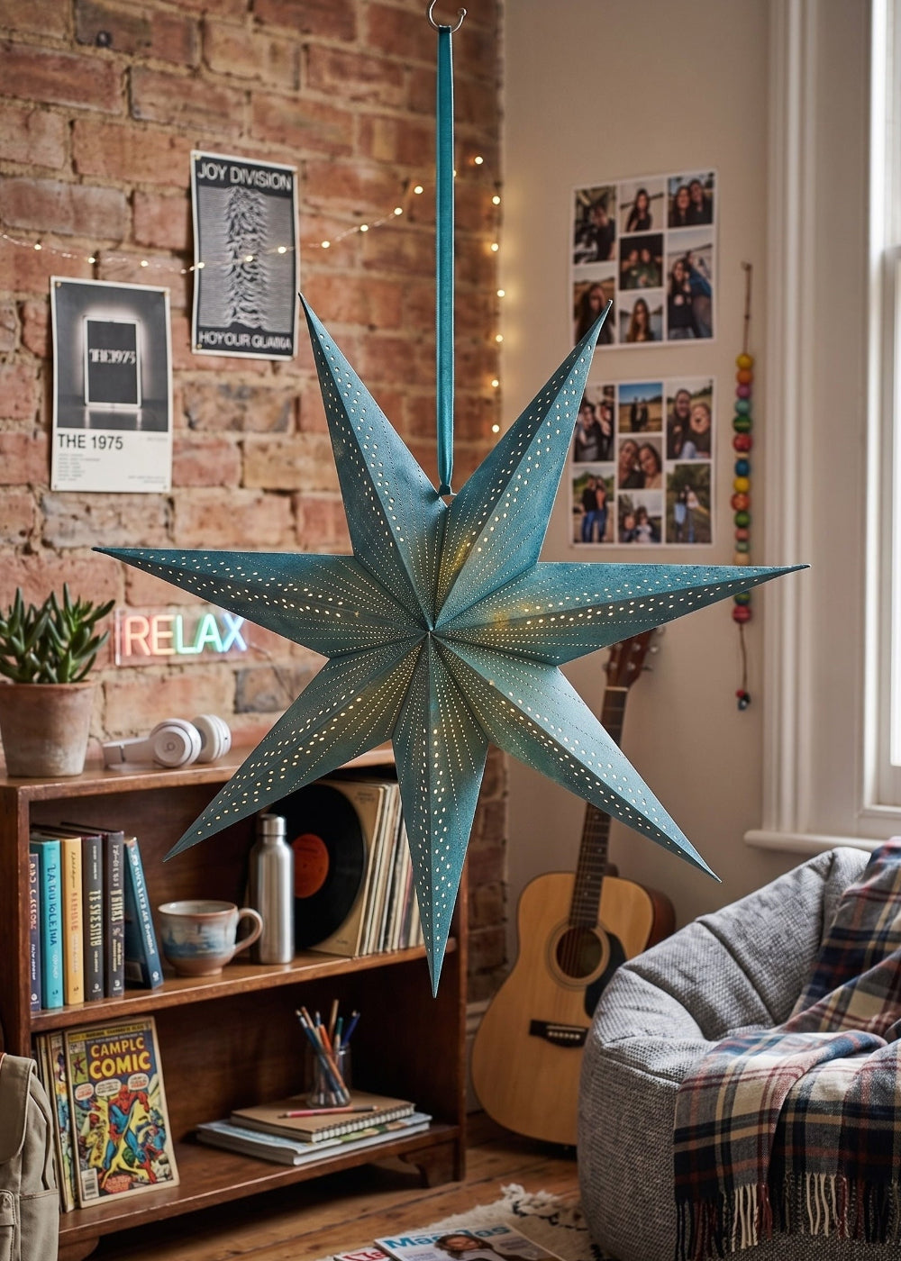 Turquoise Star Lantern in a bedroom, bookcase and sofa with a throw.