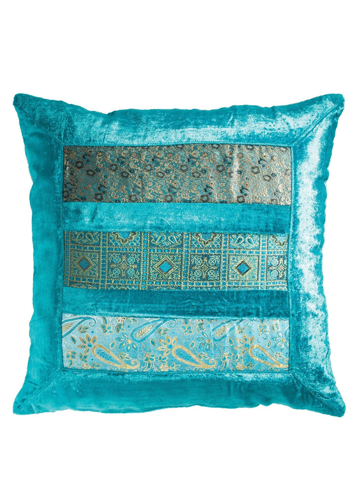 Turquoise decorative pillow with intricate patterns on a white background