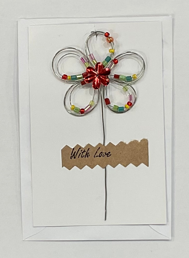 Card with a beaded flower decoration and 'With Love' text on a white background
