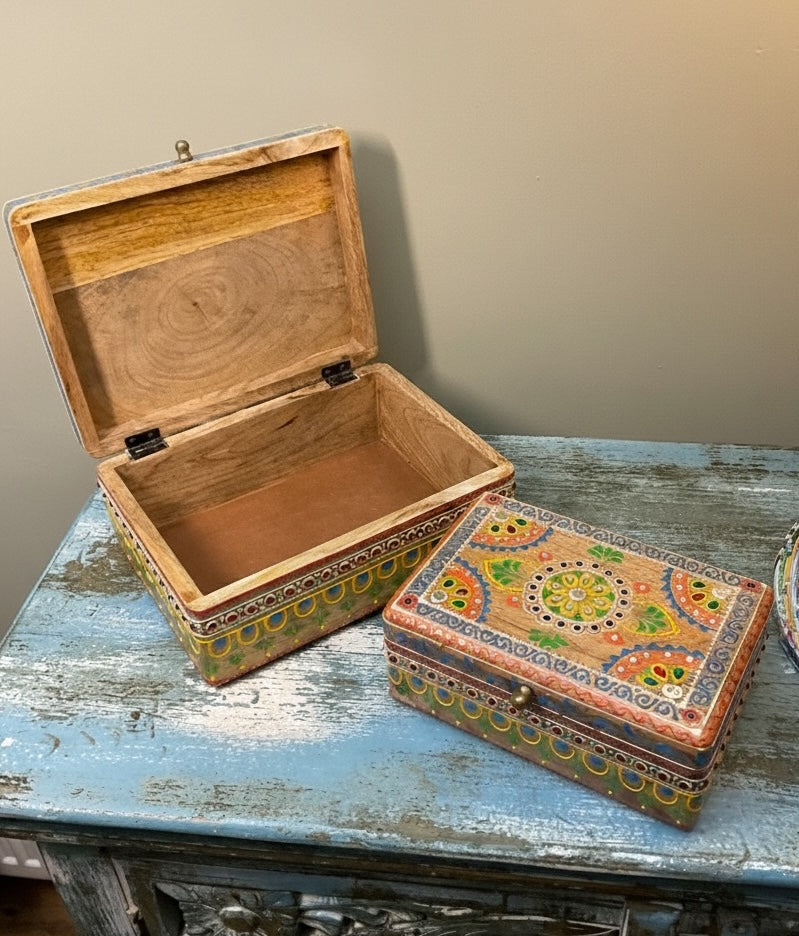 Wooden box with open lid on a rustic wooden surface