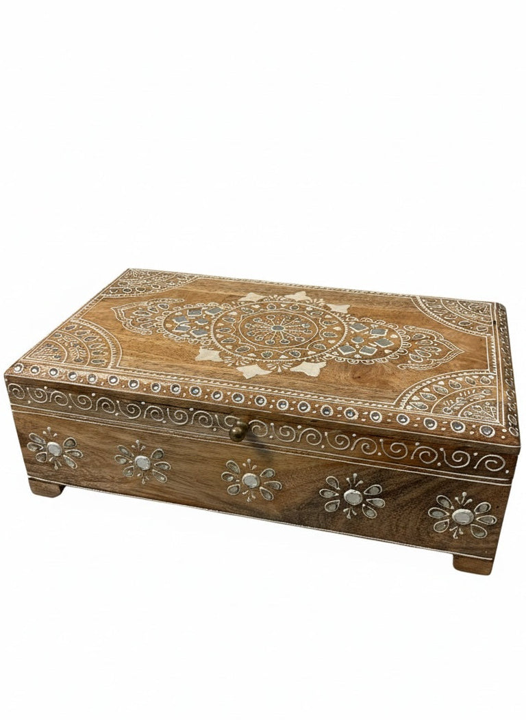 Wooden jewellery box with intricate carvings on a white background