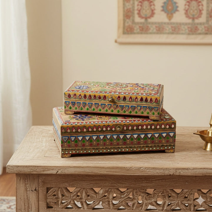 Decorative boxes with intricate patterns on a wooden table.