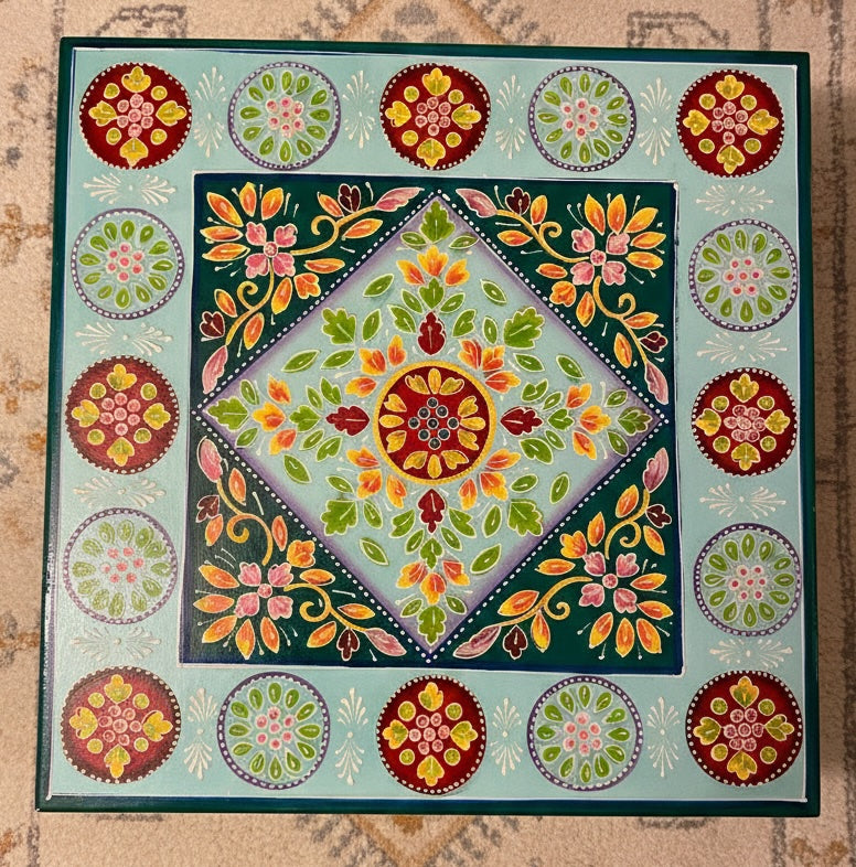 Decorative table with colourful floral patterns on a textured surface