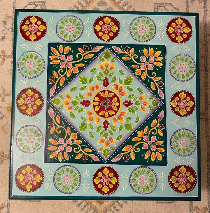 Decorative table with colourful floral patterns on a textured surface