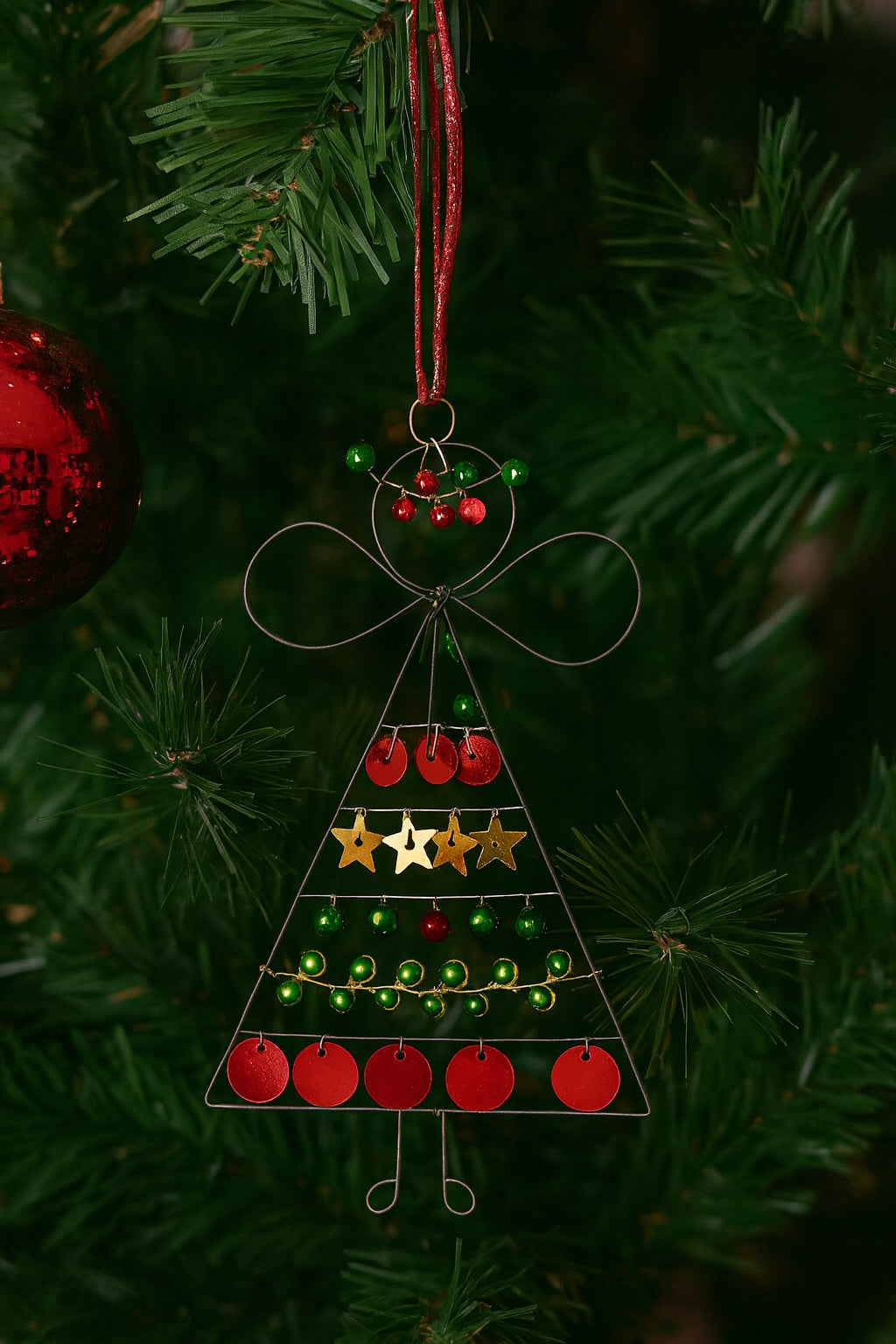 Decorative Christmas tree ornament hanging on a Christmas tree.